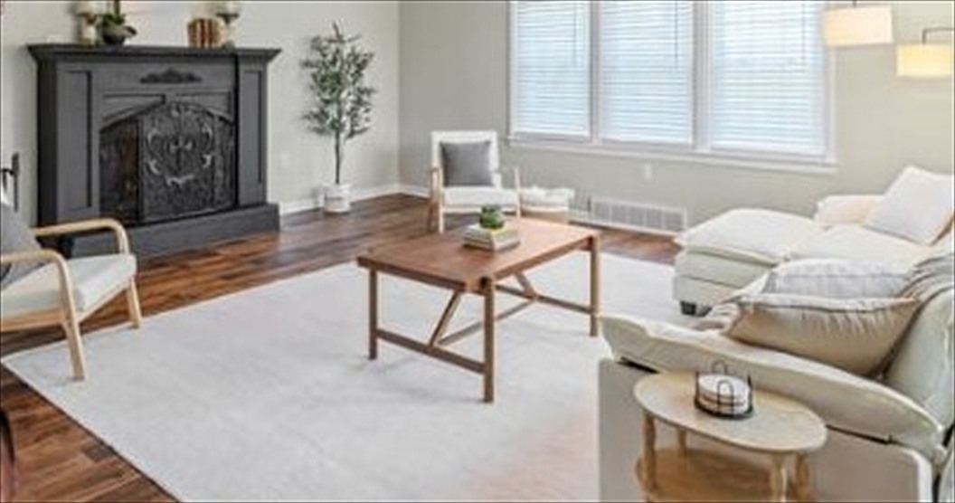 Great room with a fireplace, seating and hardwood floors